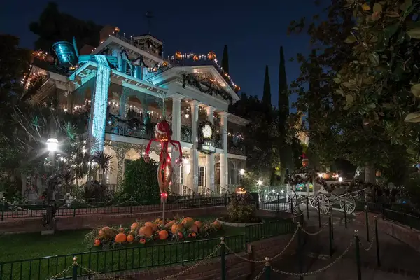 Haunted Mansion Holiday during Halloween Time at Disneyland Park features a merry makeover of the beloved eerie estate
