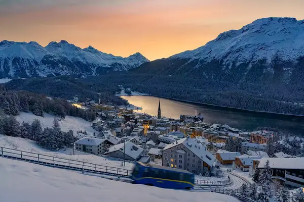 Funicular on snowy slopes above St Moriz at dawn