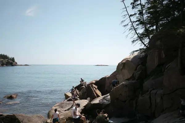 People climbing rocks in Acadia