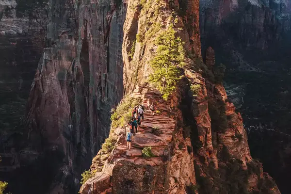Hikers going up a rocky ledge