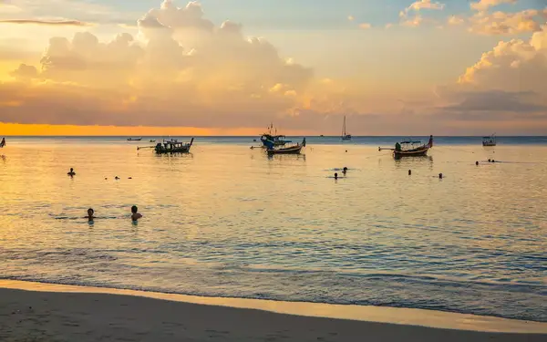 View of boats on the water at sunset in Phuket, Thailand