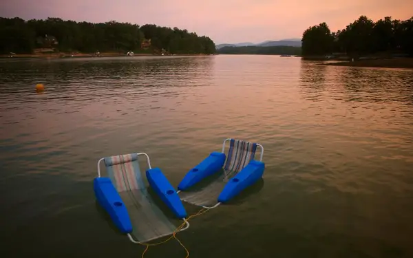 A chair of floating chairs drift in a lake near Blue Ridge, Georgia