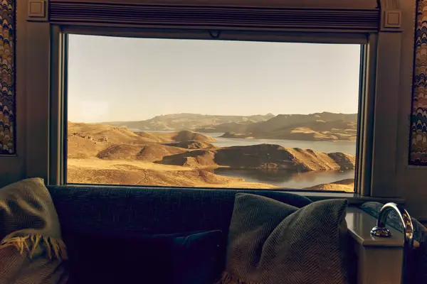 A view out a train window at mountains in Peru.