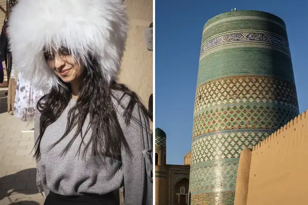 A girl wearing a fur hat stands next to a gate, the Kalta Minor Minaret is close by in the background