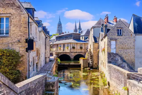 The medieval townscape of Bayeux, France, with historical architecture and a canal