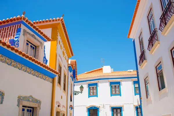 Street view of traditional buildings with tiled roofs in Ericeira, Portugal