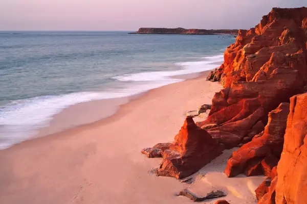 A beach in Broome, Australia, notable for its red rock formations