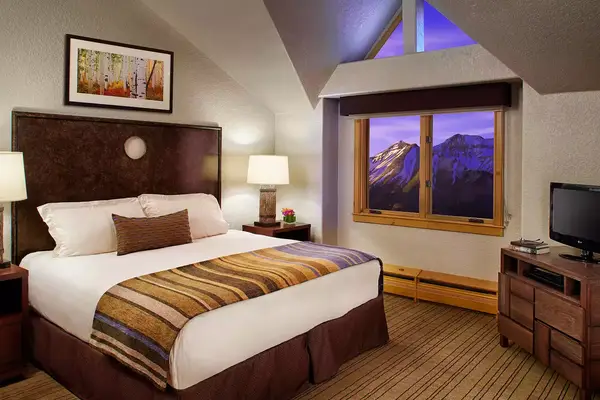 A hotel guest room with mountain views