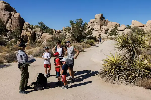 A family talks with a park ranger at Joshua Tree national Park