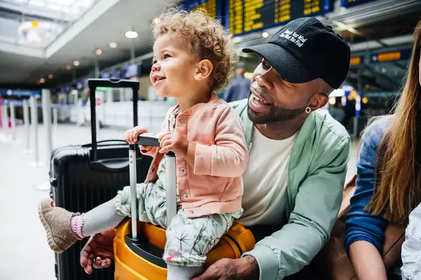 Little girl sitting on a suitcase