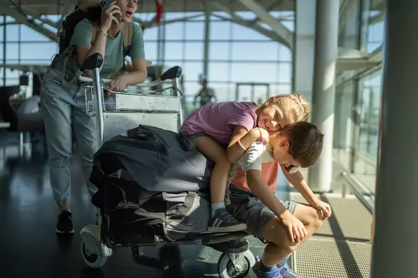 siblings playing at the airport 