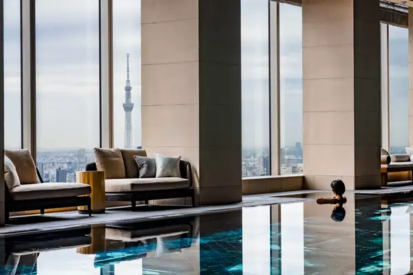 The pool with someone looking out over the Tokyo skyline at Four Seasons Hotel Tokyo at Otemachi