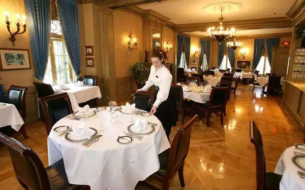 Lisa Solt, a server with 8 years of Disney experience serving customers, puts the finishing touches on a table at Disneyland