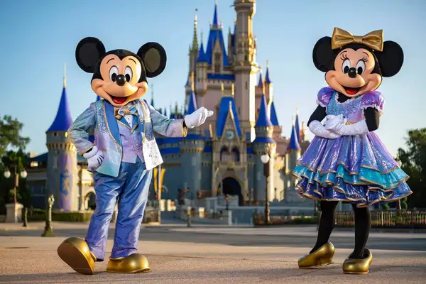 Mickey and Minnie standing in front of the Magic Castle