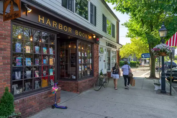 Mother and daughter pass a bookstore in Downtown Sag Harbor