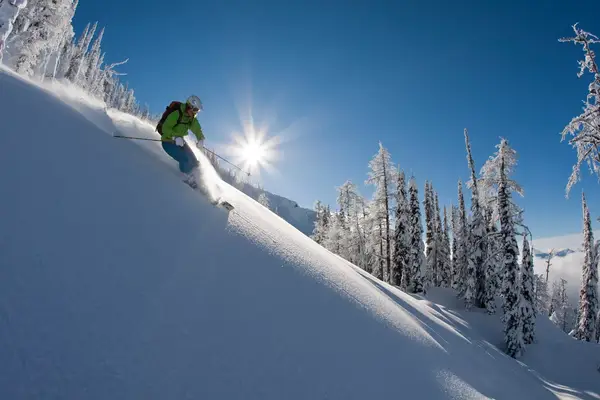 A skier going down a slope.