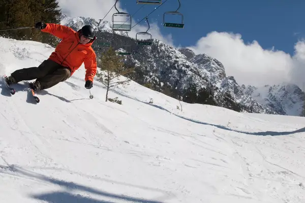 Skiier going down a hill