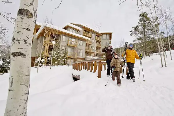 A family walking through the snow.