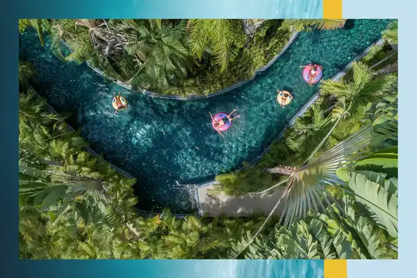 Aerial view of a family floating in tubes on a lazy river 