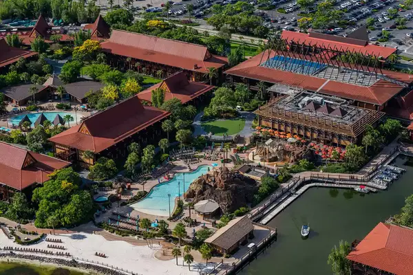 aerial view of large resort with pool and villas with red roofs