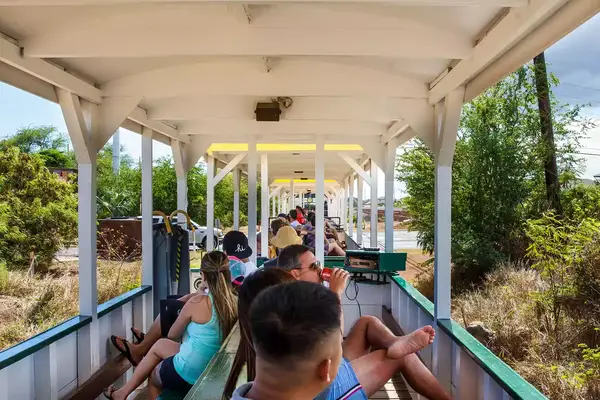 Passengers in an open car on The Hawaiian Railroad Society Train on Oahu 