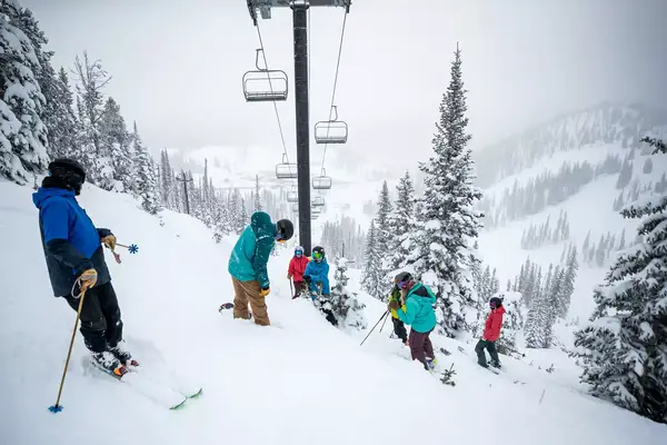 A group of skiers under a skilift