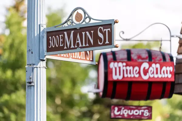 Town in Colorado with closeup of intersection sign on Main Street street and north Monarch with wine cellar liquors store