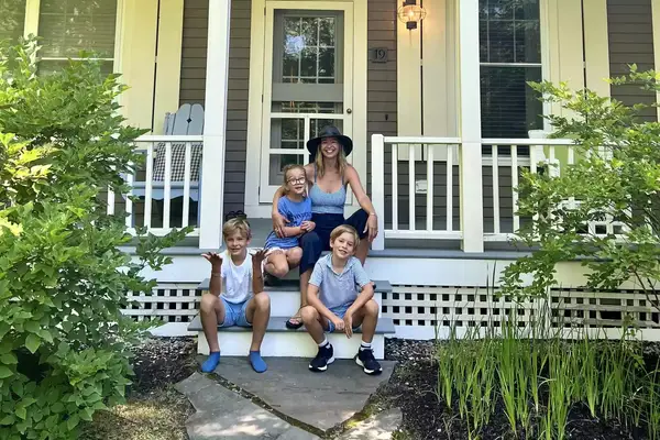 Mother with three children on the porch at Hidden Pond Resort 