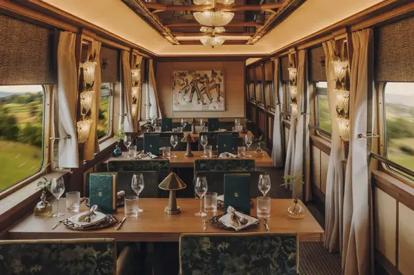 Luxurious dining car setup with elegant tableware and decor in a train compartment