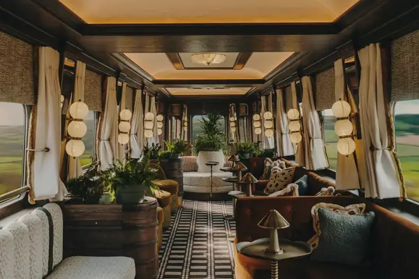 Interior of an elegant train car with luxurious seating and decor designed for a premium experience
