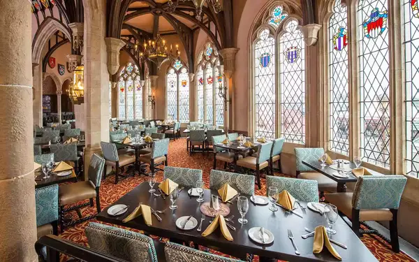 View of stained glass windows and tables inside Cinderella