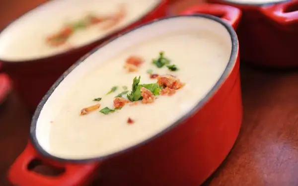 Loaded cheddar cheese soup in a cocotte at Le Cellier Steakhouse.