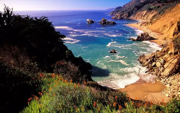 Cove with beach surrounded by rocky cliffs and bluffs
