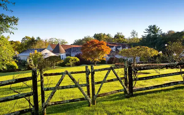 Wooden fence with a country estate in the background