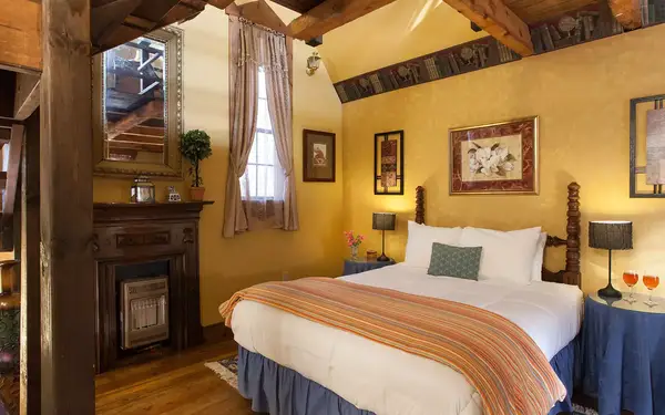 Cozy country bedroom with exposed-beam ceiling