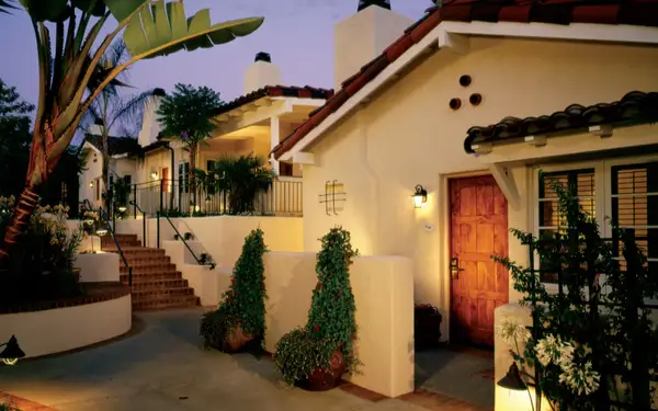 Santa Fe-style ranch lit up at dusk