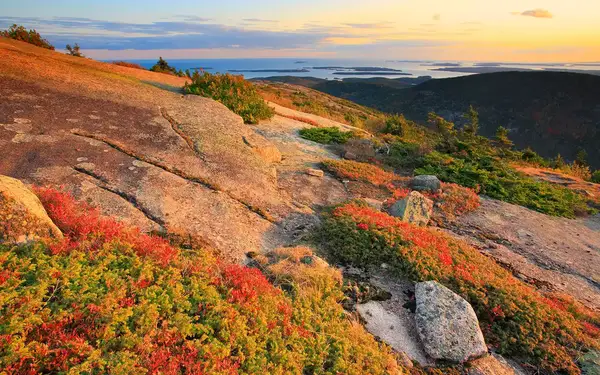 Rocky slopes dotted with autumnal-colored foliage