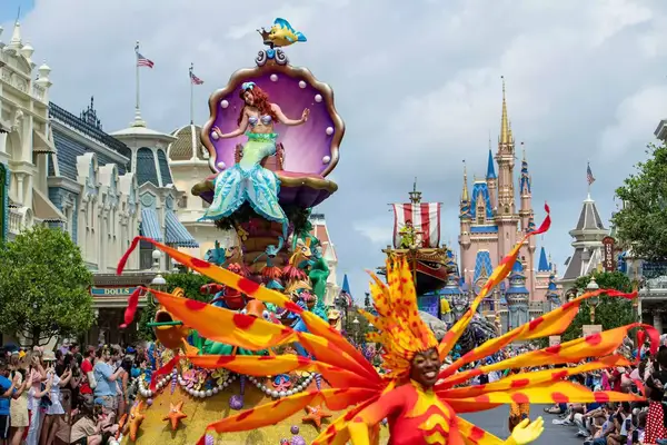 Ariel waves to guests during the âDisney Festival of Fantasy Paradeâ in Magic Kingdom Park at Walt Disney World Resort in Lake Buena Vista, Fla.