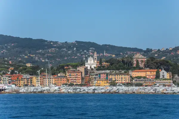 A seaside view of Santa Margherita Ligure featuring its waterfront harbor and buildings extending up the hill in the background
