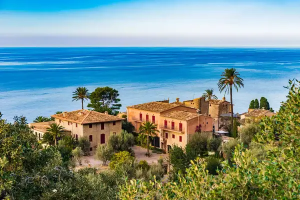 Seaside village view with buildings and trees overlooking the ocean