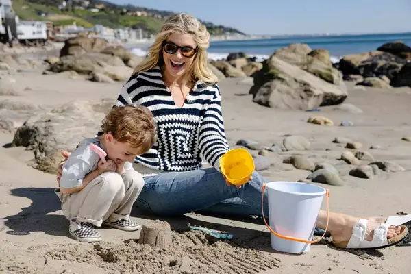 Amanda Kloots and Elvis play in the sand together on Carbon Beach in Malibu 