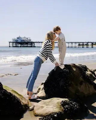 Amanda Kloots and her son, Elvis share a moment on the rocks of Carbon Beach in Malibu 
