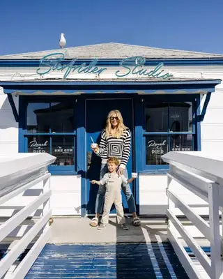 Amanda Kloots and her son, Elvis hold ice cream in front of the Surfrider Studios 