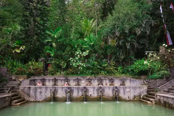 People take a bath in thermal Banjar Tega hot springs. Bali, Indonesia.