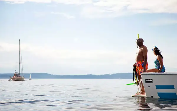 Couple in snorkeling gear on boat