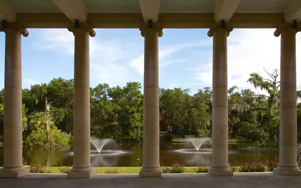 Fountains are seen through a row of stone columns in New Orleans