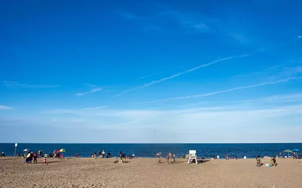Beachgoers enjoy a stretch of sand and water in Rehoboth Beach, Delaware.