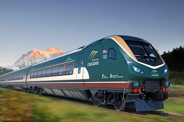 Amtrak Cascades train traveling through a scenic mountain landscape