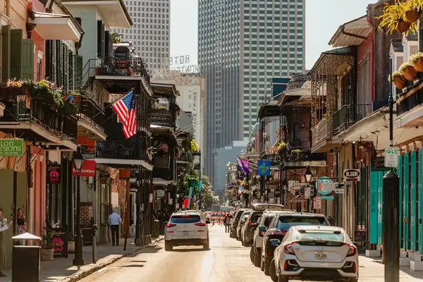 A colorful street lined with cars