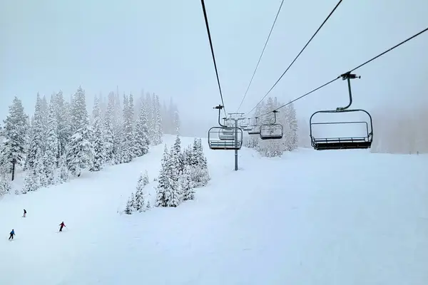 Skiers going down the mountain in Park